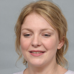 Joyful white young-adult female with medium  brown hair and blue eyes