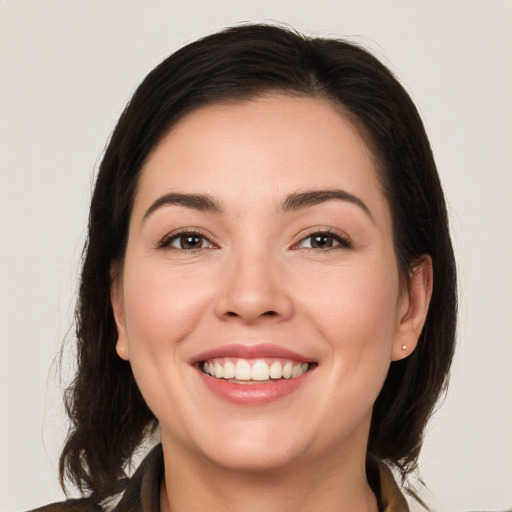 Joyful white young-adult female with medium  brown hair and brown eyes