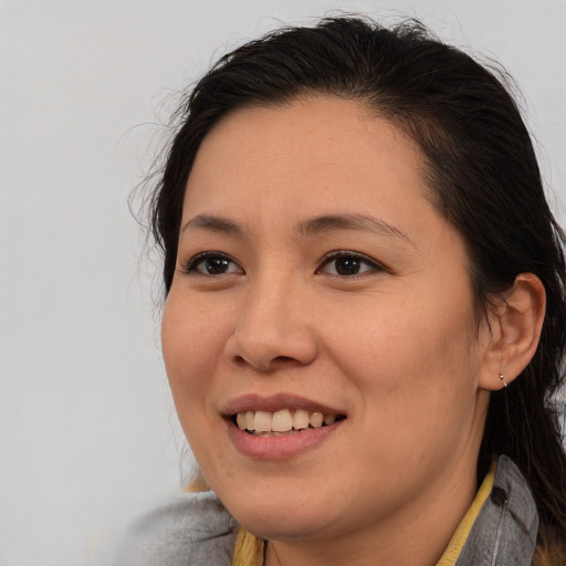 Joyful asian young-adult female with medium  brown hair and brown eyes