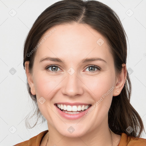 Joyful white young-adult female with medium  brown hair and grey eyes