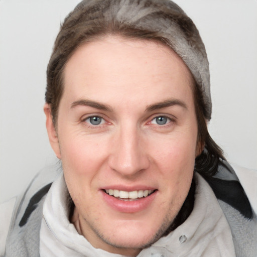 Joyful white young-adult female with medium  brown hair and blue eyes