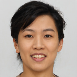 Joyful asian young-adult female with short  brown hair and brown eyes