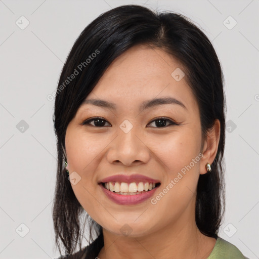 Joyful asian young-adult female with long  brown hair and brown eyes