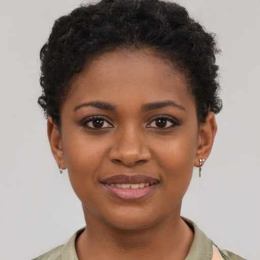 Joyful black young-adult female with short  brown hair and brown eyes