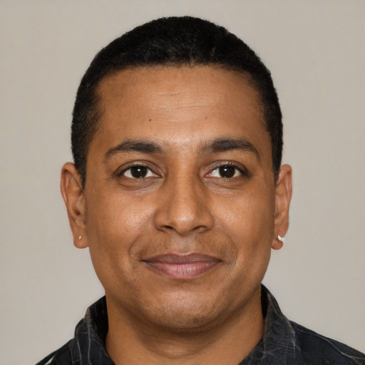 Joyful latino adult male with short  black hair and brown eyes