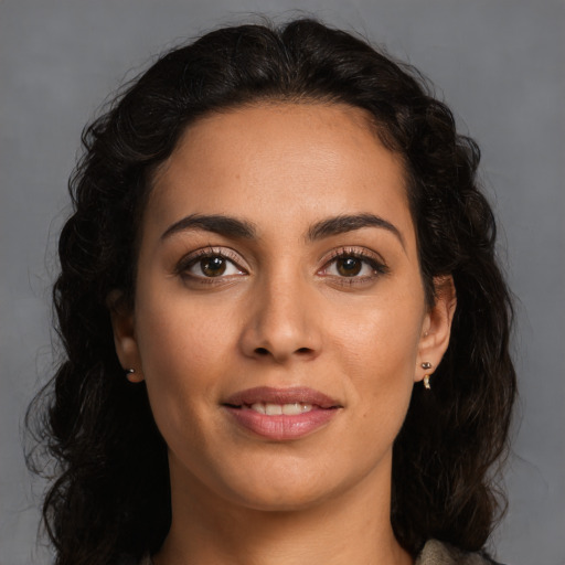 Joyful latino young-adult female with long  brown hair and brown eyes