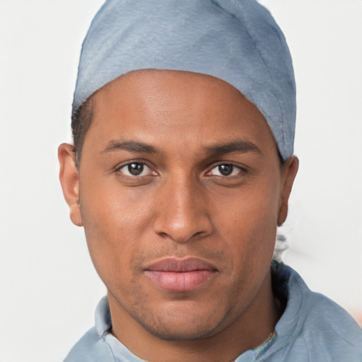 Joyful black young-adult male with short  brown hair and brown eyes