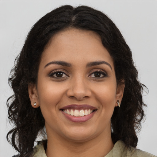 Joyful latino young-adult female with long  brown hair and brown eyes