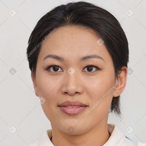 Joyful asian young-adult female with short  brown hair and brown eyes