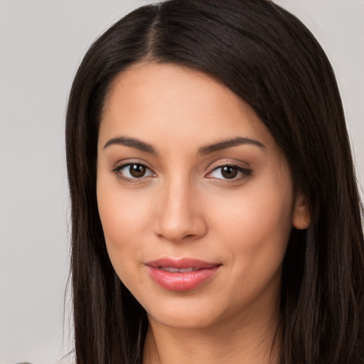 Joyful white young-adult female with long  black hair and brown eyes