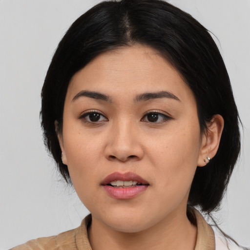 Joyful asian young-adult female with medium  black hair and brown eyes