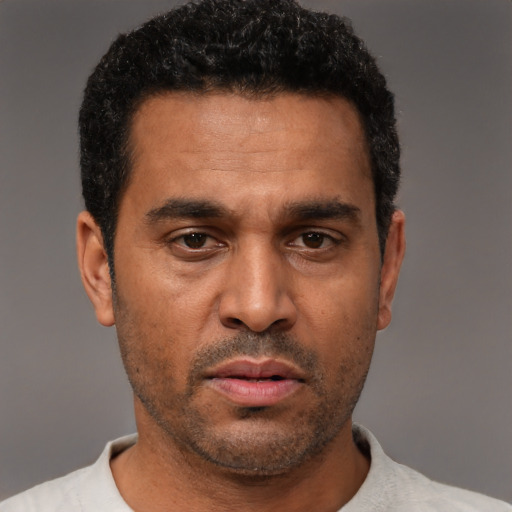Neutral black adult male with short  black hair and brown eyes