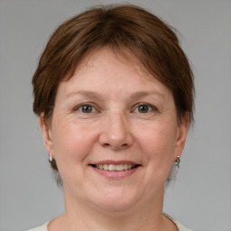 Joyful white adult female with medium  brown hair and grey eyes