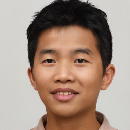 Joyful asian young-adult male with short  black hair and brown eyes