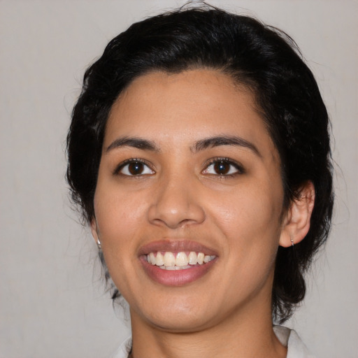 Joyful latino young-adult female with medium  black hair and brown eyes