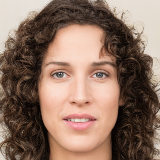 Joyful white young-adult female with long  brown hair and green eyes