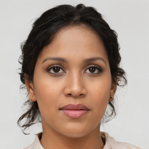 Joyful latino young-adult female with medium  brown hair and brown eyes