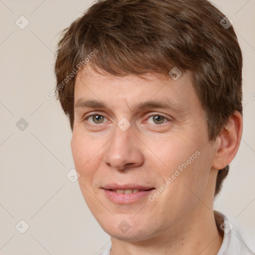 Joyful white adult male with short  brown hair and brown eyes