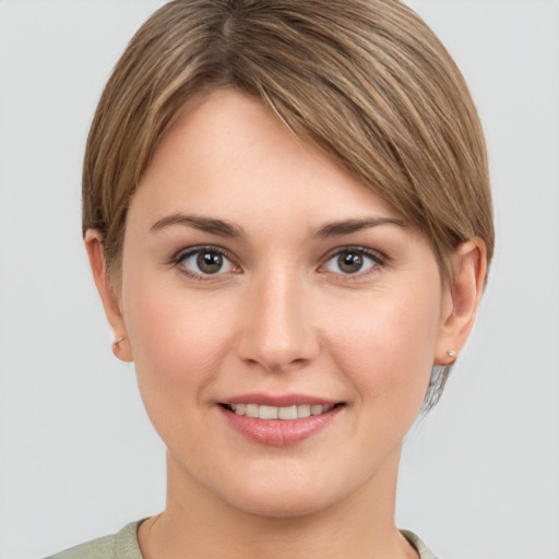 Joyful white young-adult female with short  brown hair and brown eyes