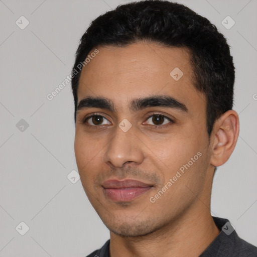 Joyful latino young-adult male with short  black hair and brown eyes