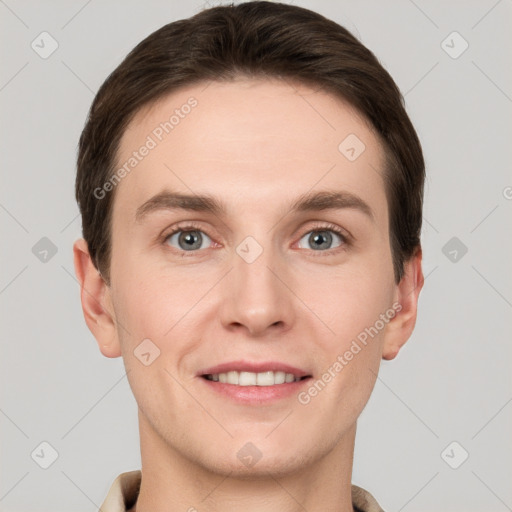 Joyful white young-adult male with short  brown hair and grey eyes