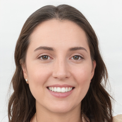 Joyful white young-adult female with long  brown hair and grey eyes