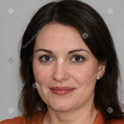 Joyful white adult female with medium  brown hair and brown eyes