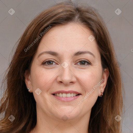 Joyful white adult female with long  brown hair and grey eyes