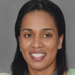 Joyful black adult female with medium  brown hair and brown eyes