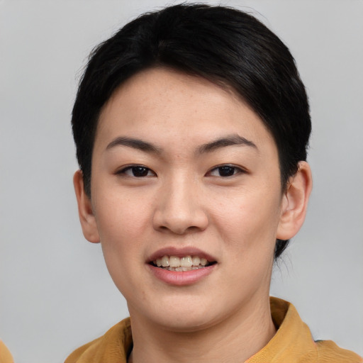 Joyful asian young-adult female with short  black hair and brown eyes