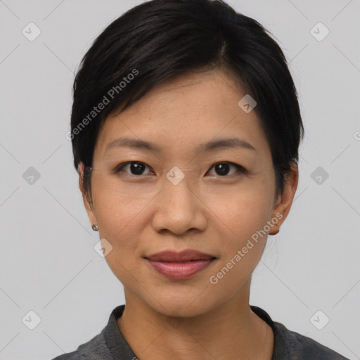 Joyful asian young-adult female with short  black hair and brown eyes