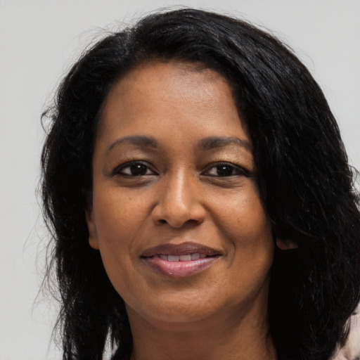Joyful latino adult female with long  black hair and brown eyes