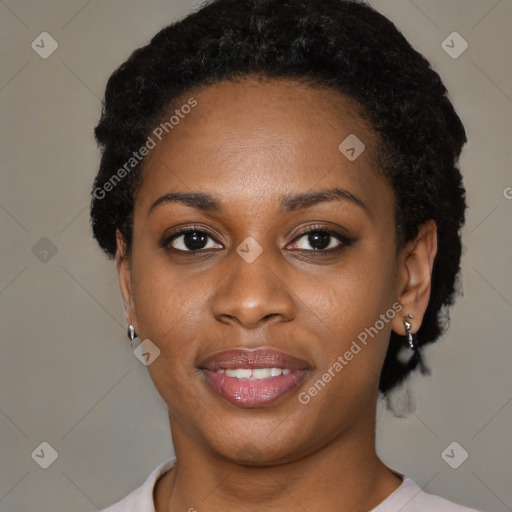 Joyful black young-adult female with short  black hair and brown eyes