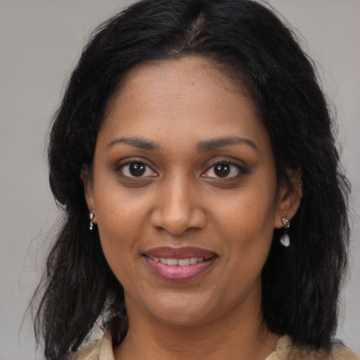 Joyful black young-adult female with medium  brown hair and brown eyes