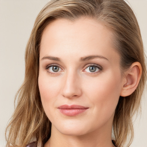 Joyful white young-adult female with long  brown hair and blue eyes