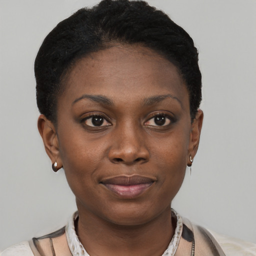 Joyful black young-adult female with short  black hair and brown eyes
