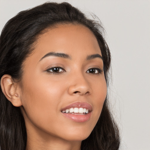 Joyful latino young-adult female with long  brown hair and brown eyes