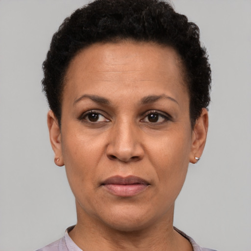Joyful latino adult female with short  brown hair and brown eyes