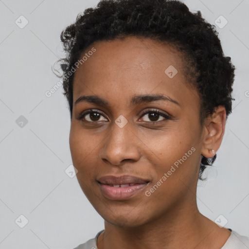 Joyful black young-adult female with short  black hair and brown eyes