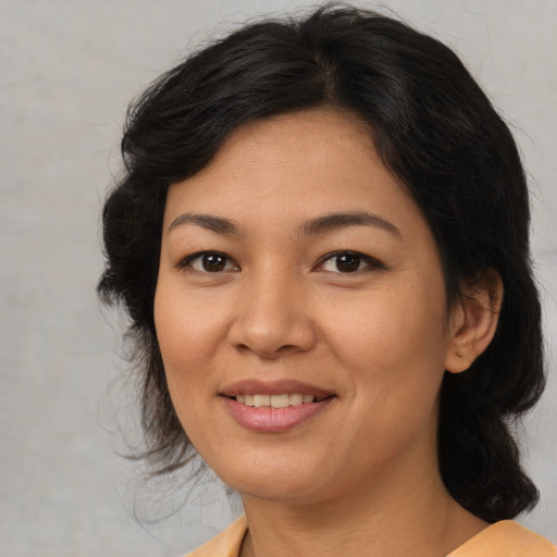 Joyful asian young-adult female with medium  brown hair and brown eyes