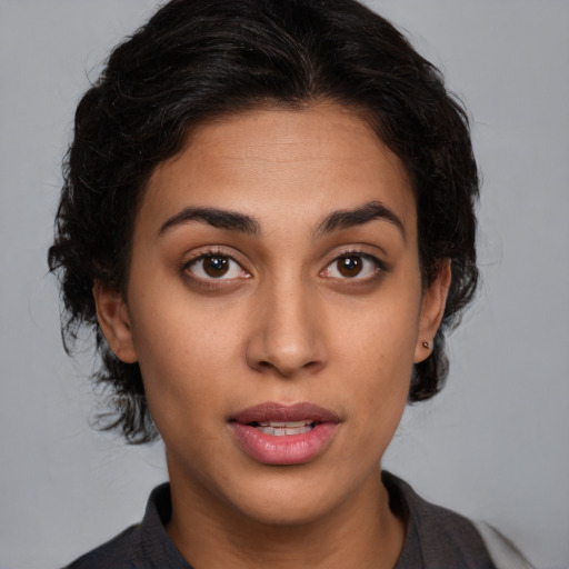 Joyful latino young-adult female with short  brown hair and brown eyes