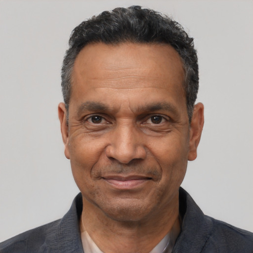 Joyful latino adult male with short  black hair and brown eyes