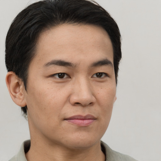 Joyful latino young-adult male with short  brown hair and brown eyes