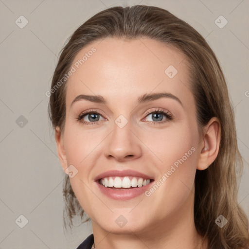 Joyful white young-adult female with medium  brown hair and grey eyes