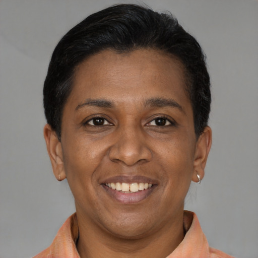 Joyful latino adult female with short  brown hair and brown eyes