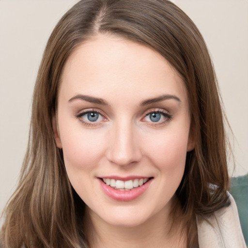 Joyful white young-adult female with long  brown hair and green eyes