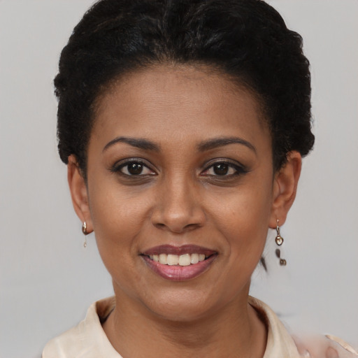 Joyful latino young-adult female with short  black hair and brown eyes
