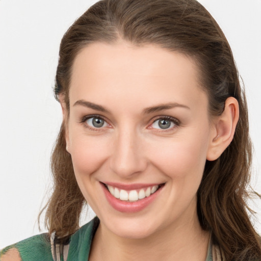 Joyful white young-adult female with long  brown hair and grey eyes