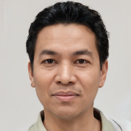 Joyful asian adult male with short  black hair and brown eyes