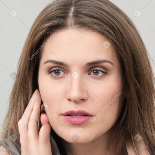 Neutral white young-adult female with long  brown hair and brown eyes